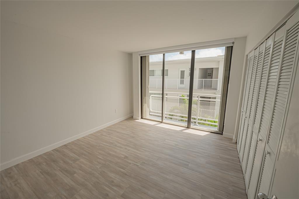 468 Golden Isles Drive, Unit 402 Hallandale Beach, FL 33009 - Photo 31 of 53 wooden floor and window in an empty room