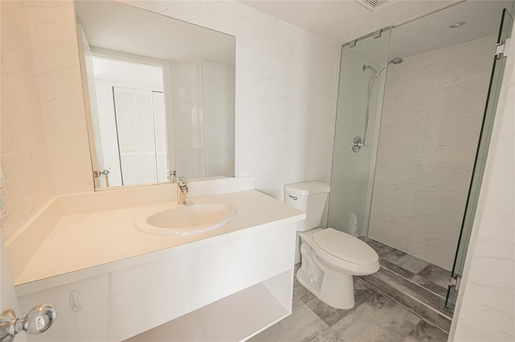 468 Golden Isles Drive, Unit 402 Hallandale Beach, FL 33009 - Photo 35 of 53 a bathroom with a sink and a toilet
