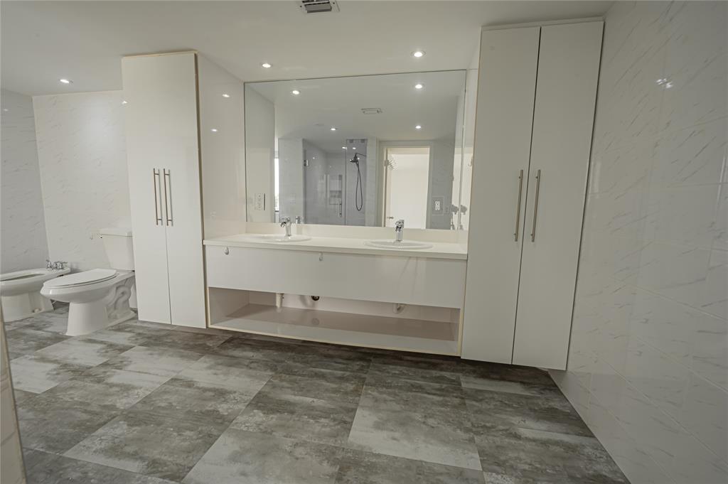 468 Golden Isles Drive, Unit 402 Hallandale Beach, FL 33009 - Photo 46 of 53 a bathroom with a sink and a mirror