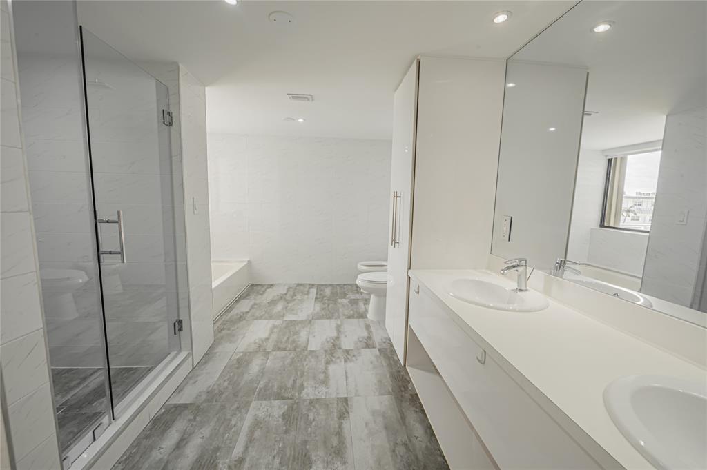 468 Golden Isles Drive, Unit 402 Hallandale Beach, FL 33009 - Photo 48 of 53 a bathroom with a double vanity sink and mirror