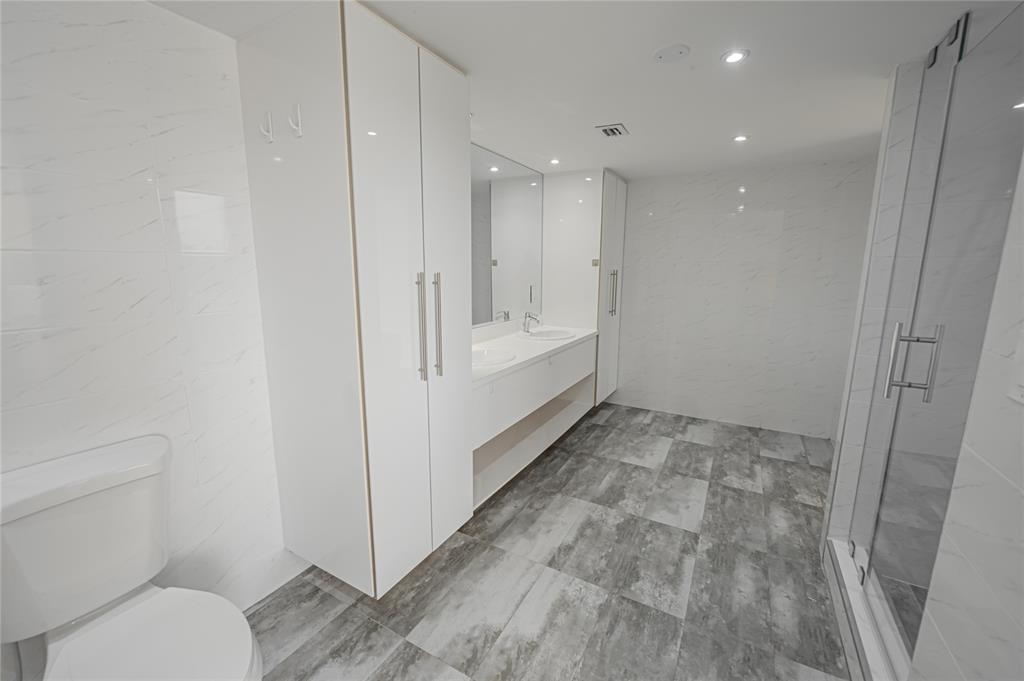 468 Golden Isles Drive, Unit 402 Hallandale Beach, FL 33009 - Photo 52 of 53 a bathroom with a sink and a toilet