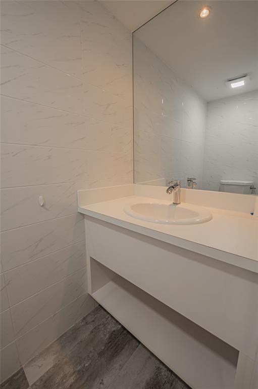 468 Golden Isles Drive, Unit 402 Hallandale Beach, FL 33009 - Photo 9 of 53 a bathroom with a sink and a mirror