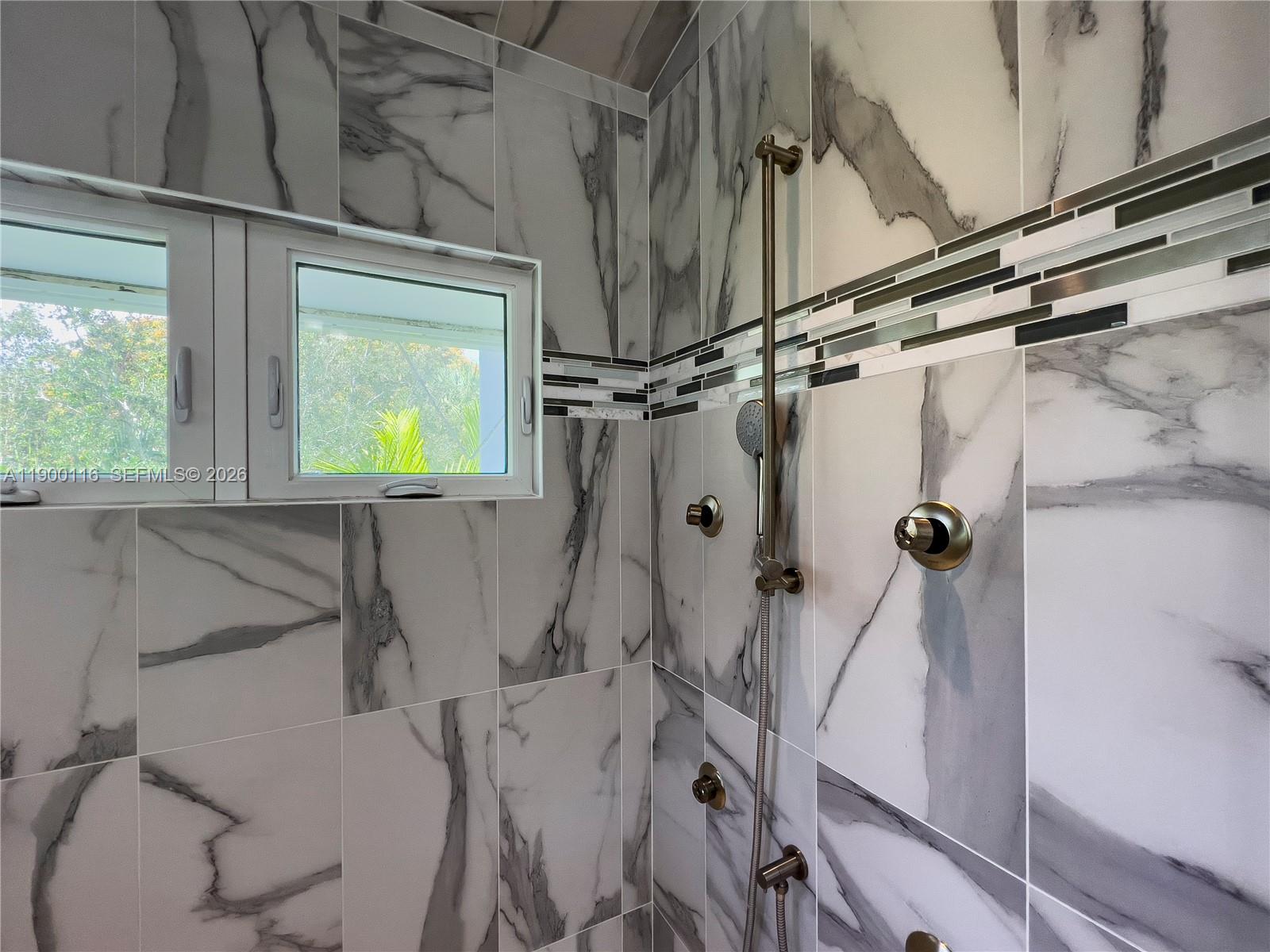 545 Southwest Indianola Street Stuart, FL 34994 - Photo 33 of 64 a bathroom with a sink and shower