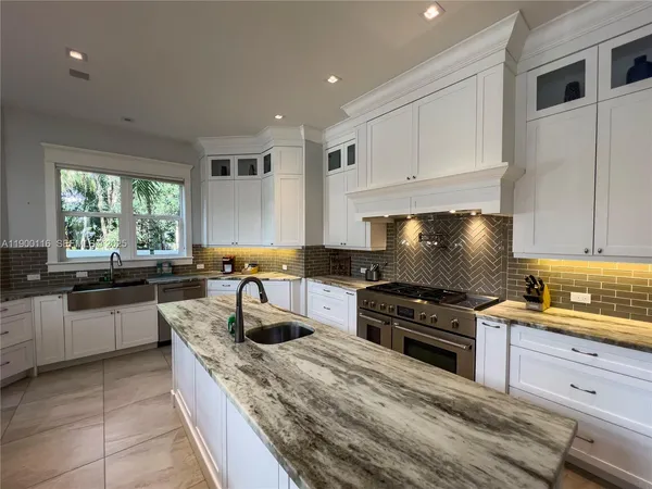 a kitchen with a sink and large window