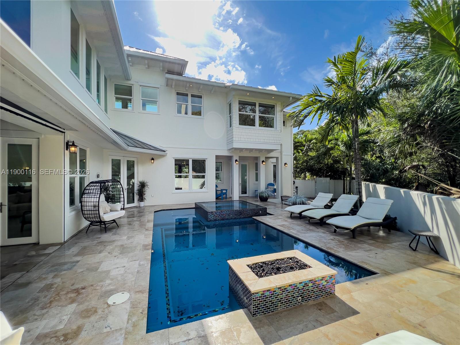 545 Southwest Indianola Street Stuart, FL 34994 - Photo 54 of 64 a view of a patio with couches table and chairs with wooden floor and fence