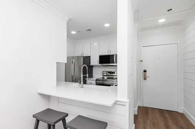 a kitchen with a refrigerator and a sink
