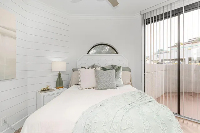 a bedroom with a bed and a mirror