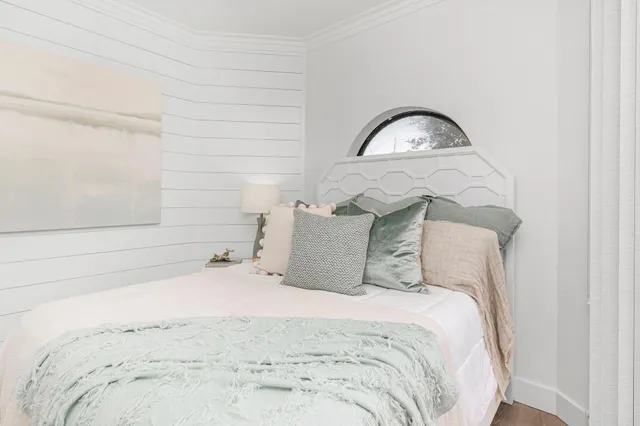 a bedroom with a bed and a chair