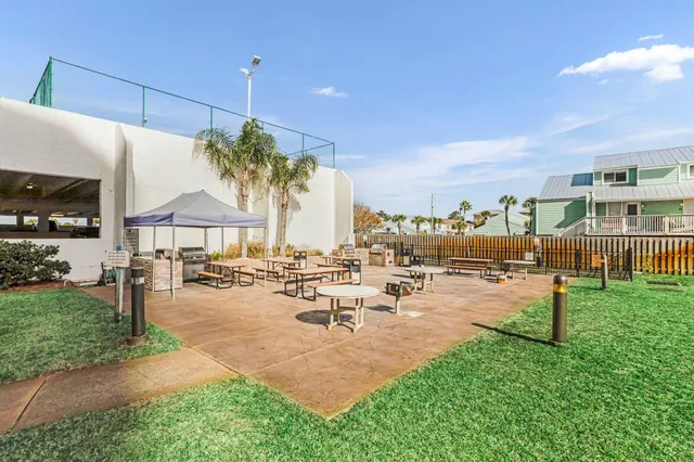 a view of a patio with a table and chairs under an umbrella