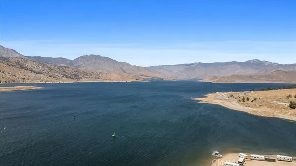 a view of mountain with lake in background