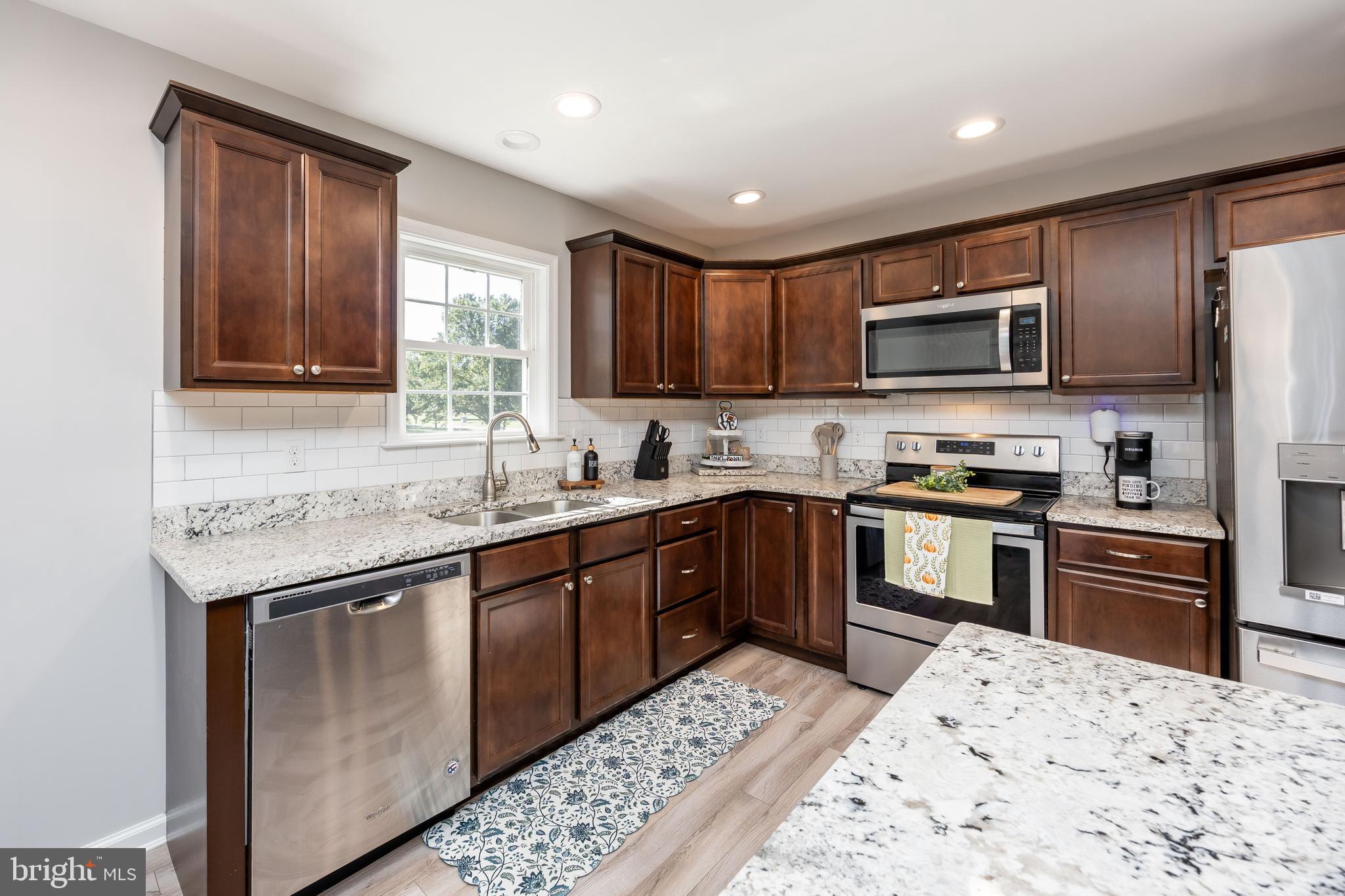 211 Moonglow Road Fruitland, MD 21826 - Photo 12 of 67 a kitchen with stainless steel appliances granite countertop a refrigerator stove microwave and sink