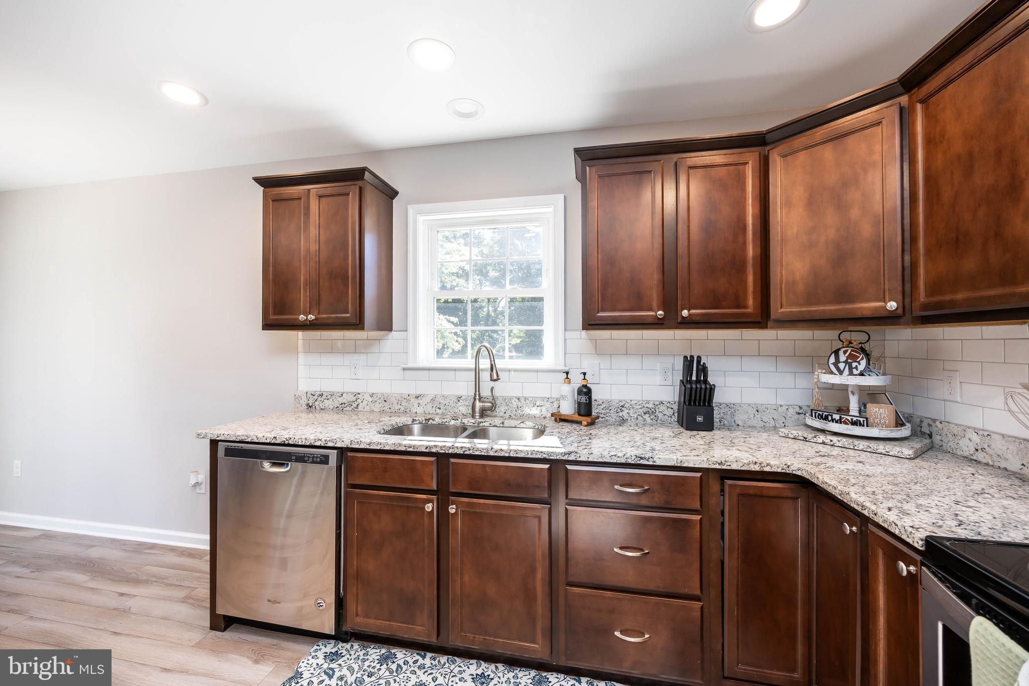 211 Moonglow Road Fruitland, MD 21826 - Photo 16 of 67 a kitchen with granite countertop stainless steel appliances a sink window and cabinets