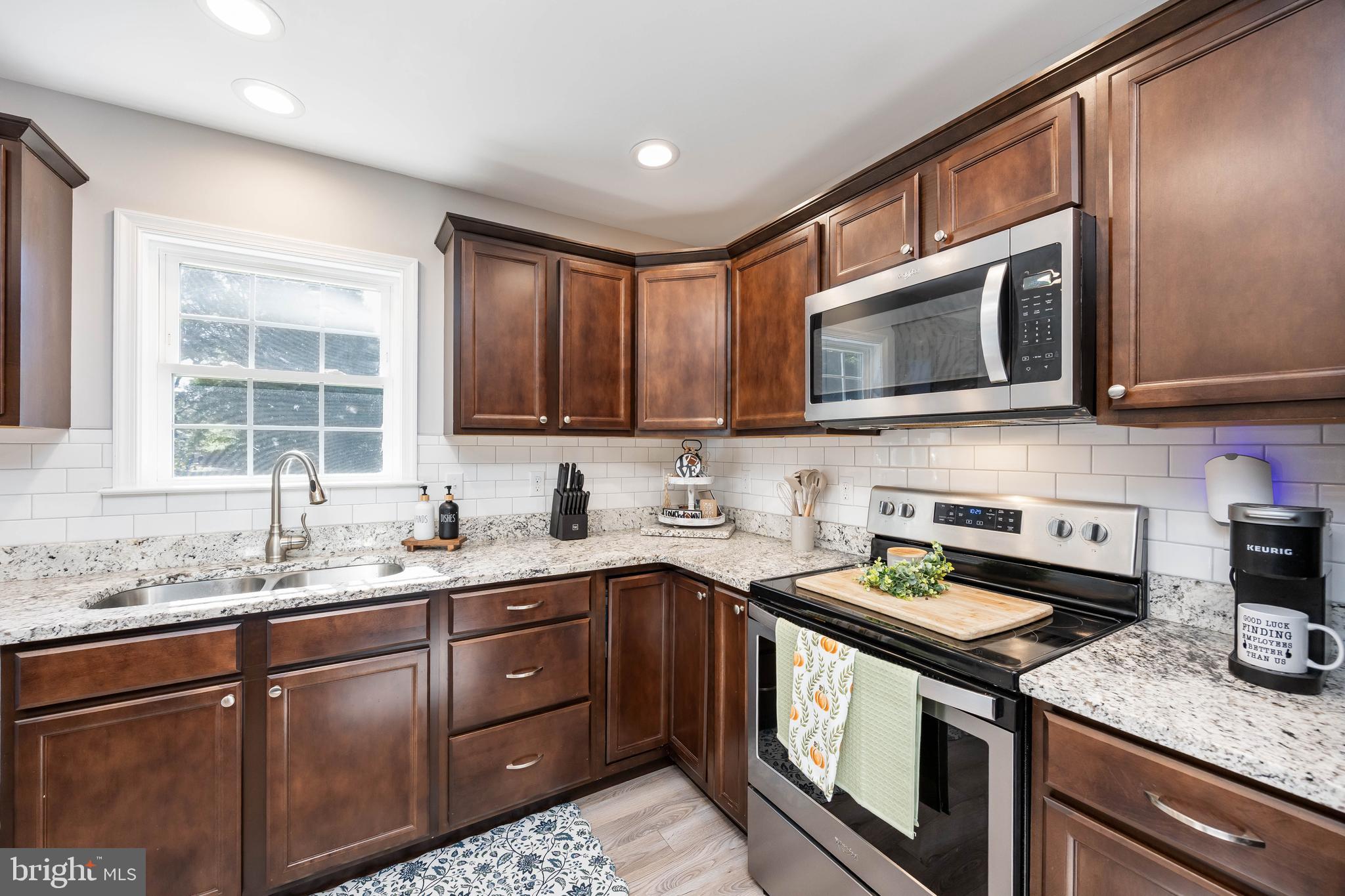 211 Moonglow Road Fruitland, MD 21826 - Photo 17 of 67 a kitchen with stainless steel appliances granite countertop a sink stove microwave and cabinets