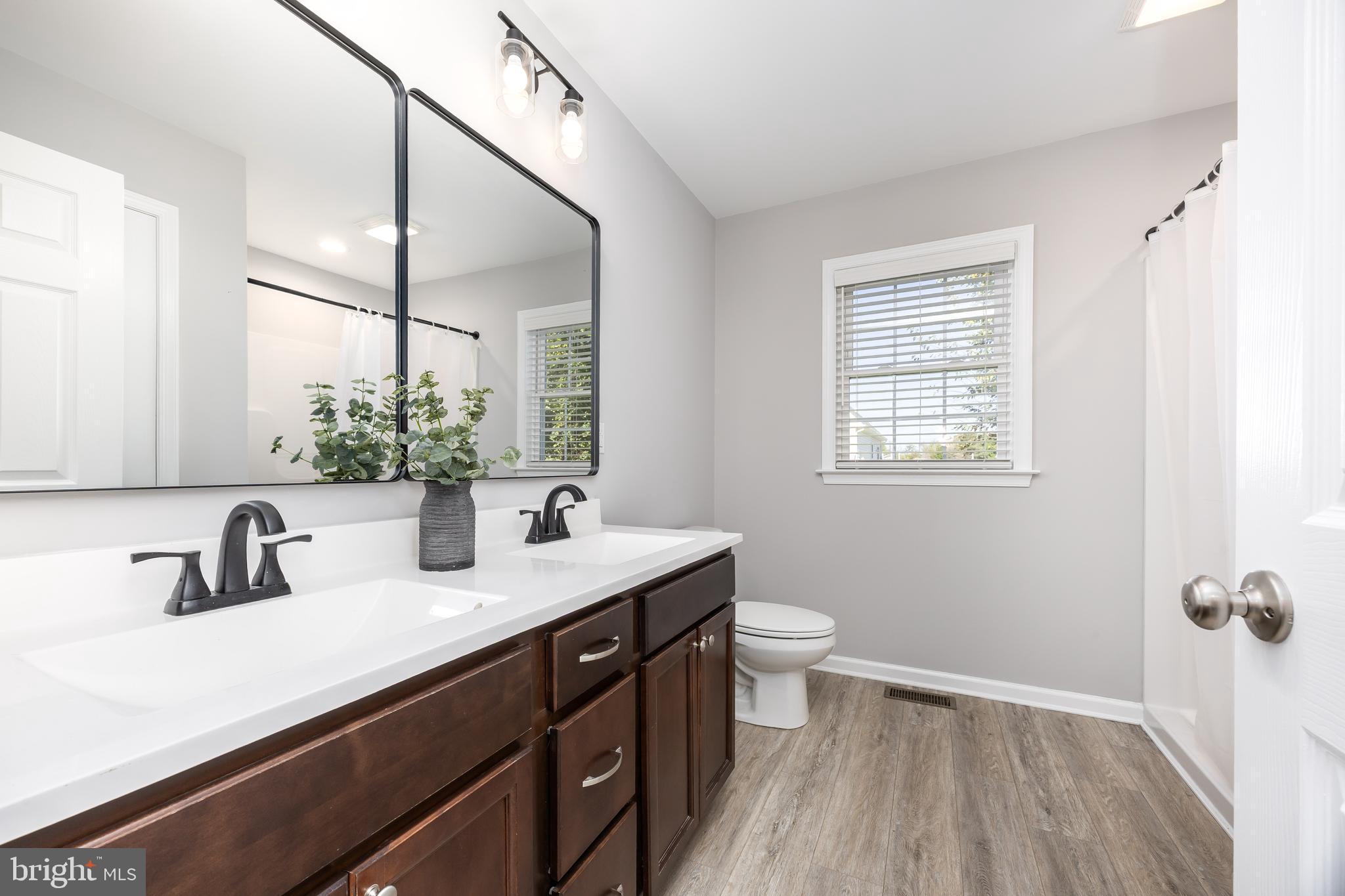 211 Moonglow Road Fruitland, MD 21826 - Photo 26 of 67 a bathroom with a sink a toilet a mirror and shower
