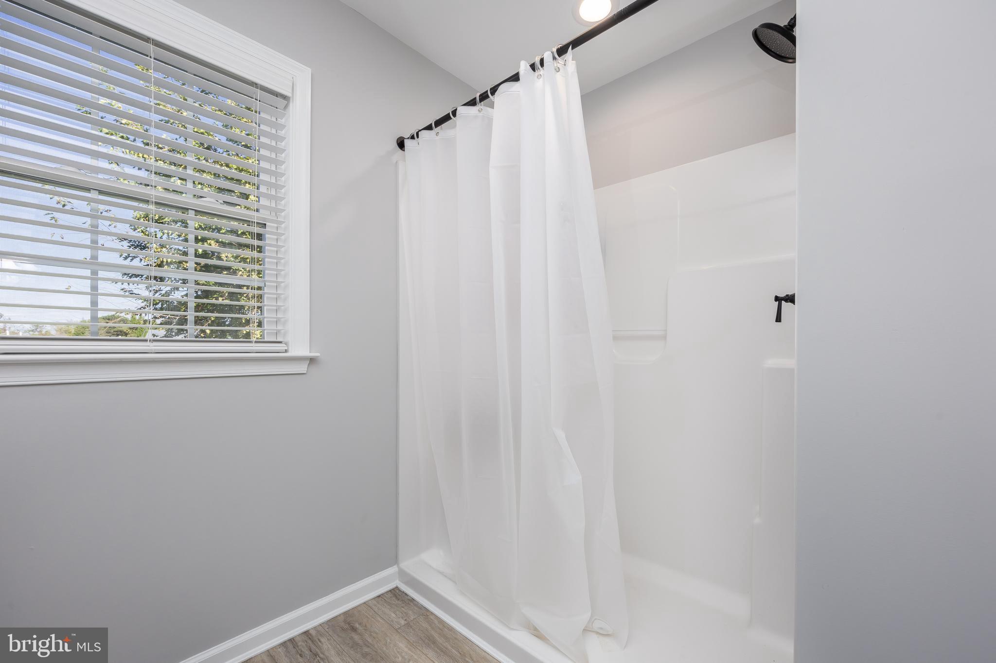 211 Moonglow Road Fruitland, MD 21826 - Photo 29 of 67 a view of a small space with a window and a shower curtain