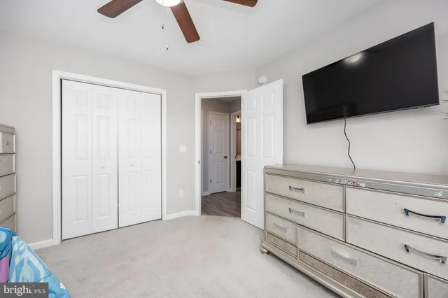 a bathroom with a toilet and a shower curtain