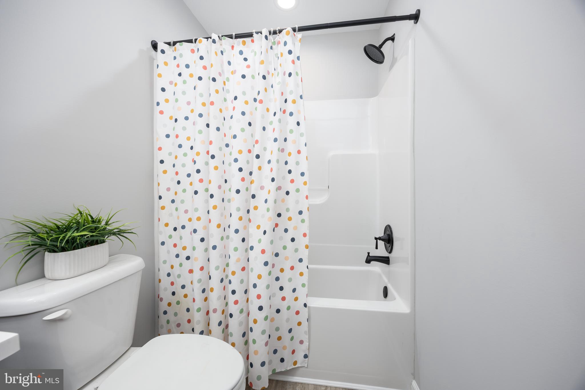 211 Moonglow Road Fruitland, MD 21826 - Photo 40 of 67 a bathroom with a toilet and a shower curtain