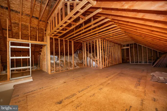 a front view of a house with a garden and yard