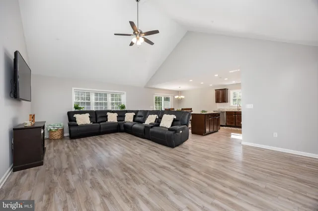 a view of a livingroom with furniture and a ceiling fan