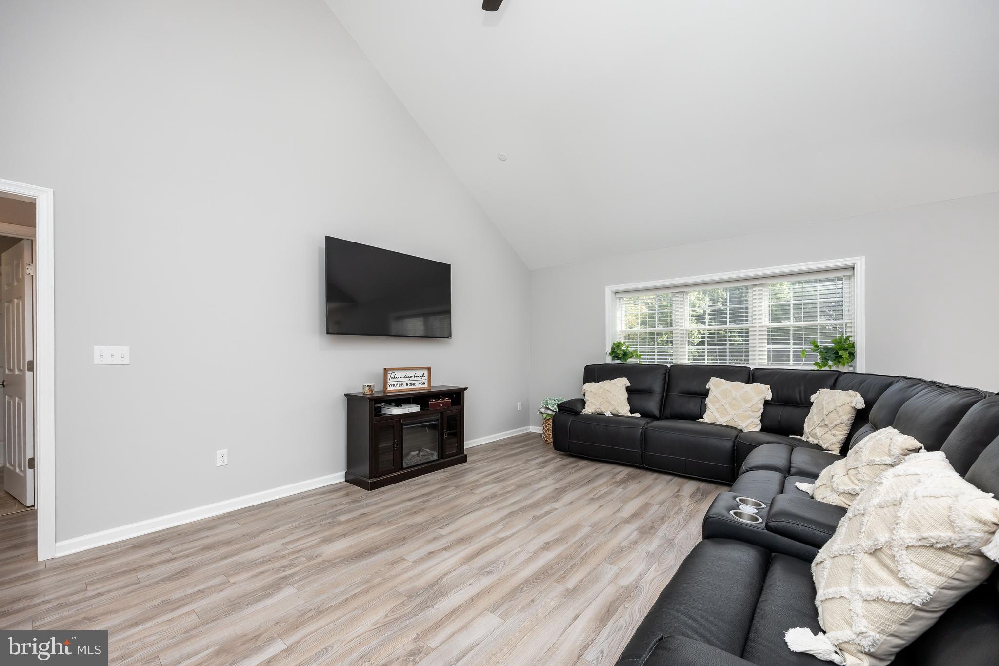 211 Moonglow Road Fruitland, MD 21826 - Photo 6 of 67 a living room with furniture and a flat screen tv