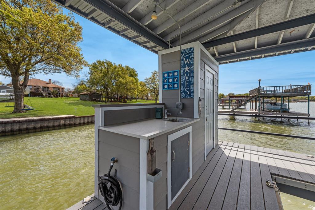 13032 Rudy's Way Streetman, TX 75859 - Photo 38 of 40 Dock cleanup station with sink, covered deck space, and waterfront convenience.