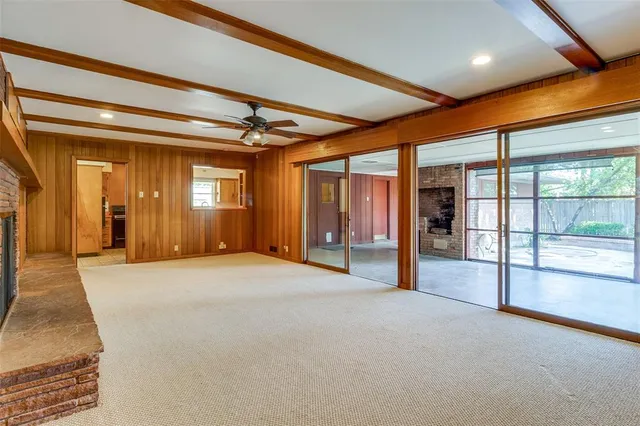 a large kitchen with stainless steel appliances granite countertop a sink counter space cabinets and a large window