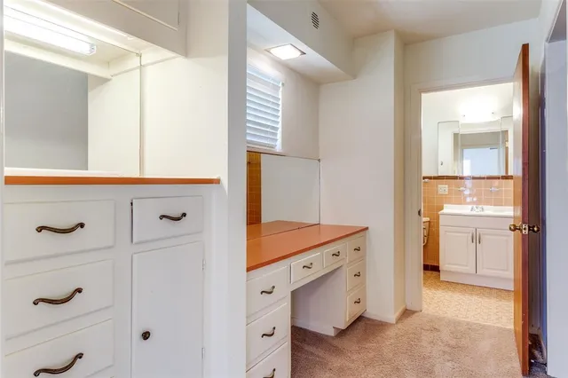 a bathroom with a granite countertop sink a mirror and a bathtub