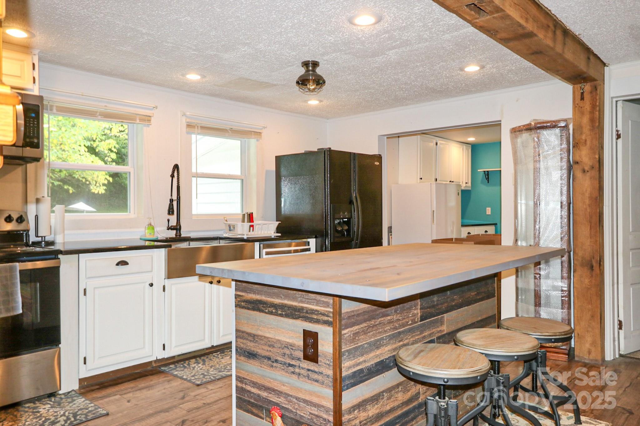 11979 Sparta Road McGrady, NC 28649 - Photo 11 of 48 a kitchen with a stove a refrigerator and a sink
