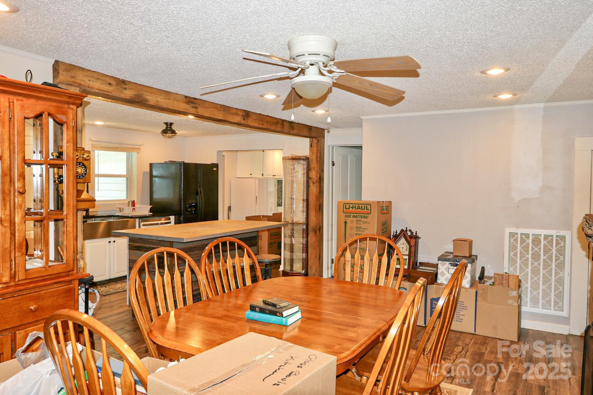 11979 Sparta Road McGrady, NC 28649 - Photo 16 of 48 a view of a dining room with furniture a chandelier and wooden floor