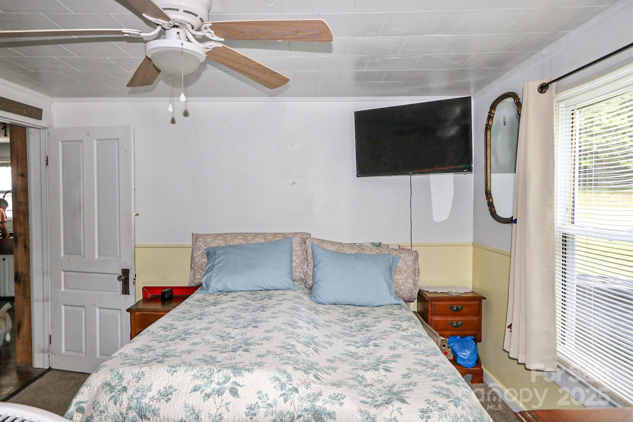 11979 Sparta Road McGrady, NC 28649 - Photo 22 of 48 a bedroom with a bed and wooden floor