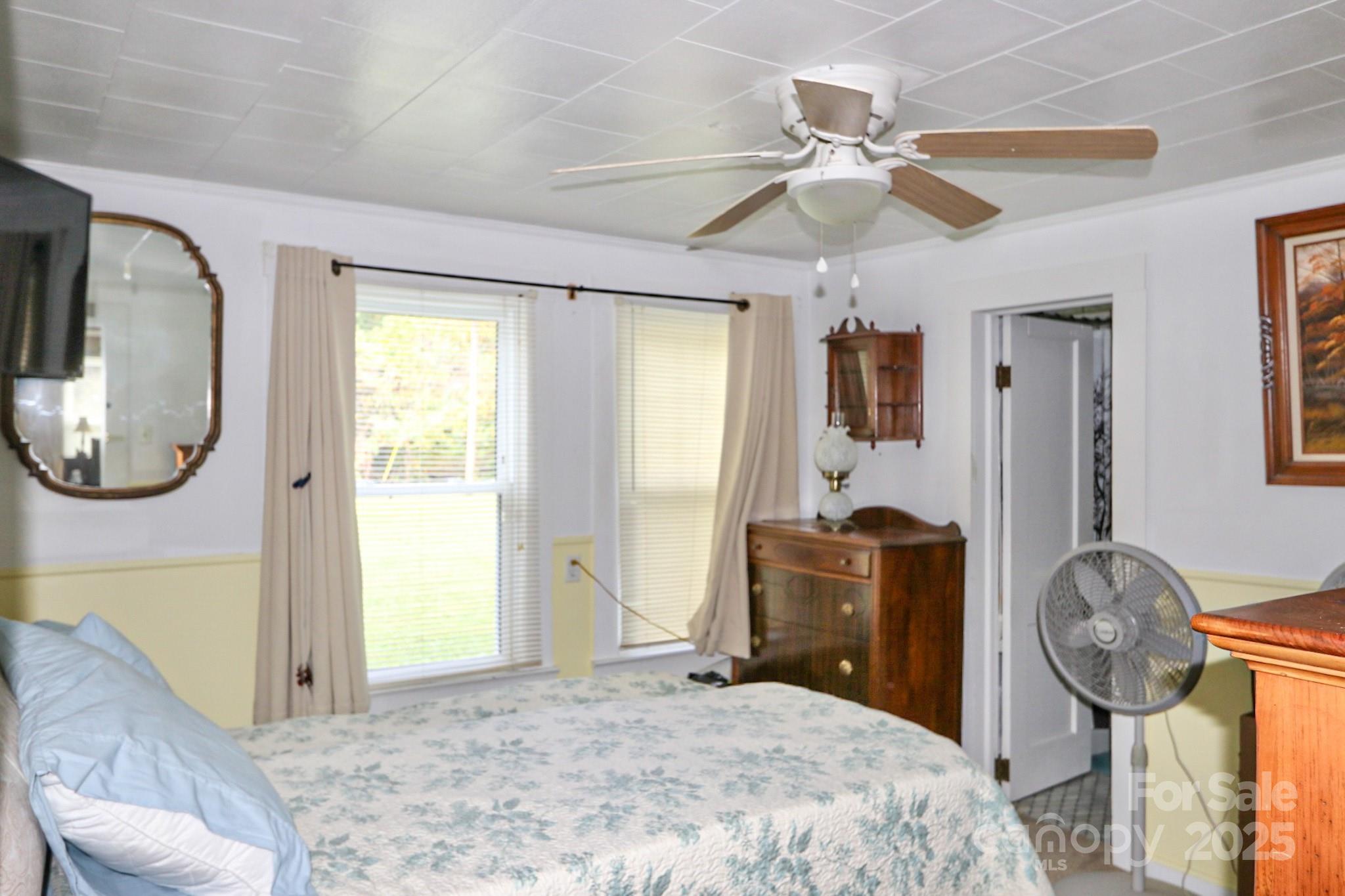11979 Sparta Road McGrady, NC 28649 - Photo 23 of 48 a bedroom with a bed mirror and window