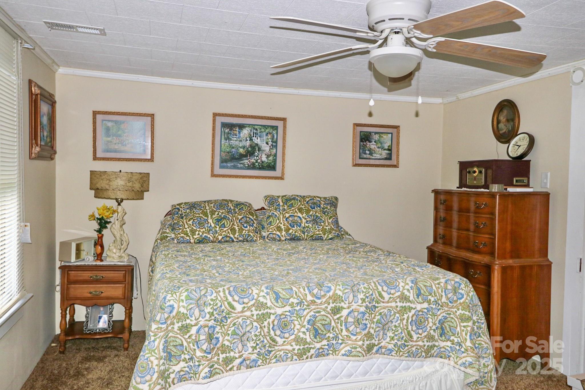 11979 Sparta Road McGrady, NC 28649 - Photo 25 of 48 a bedroom with a bed and a lamp on dresser with wooden floor
