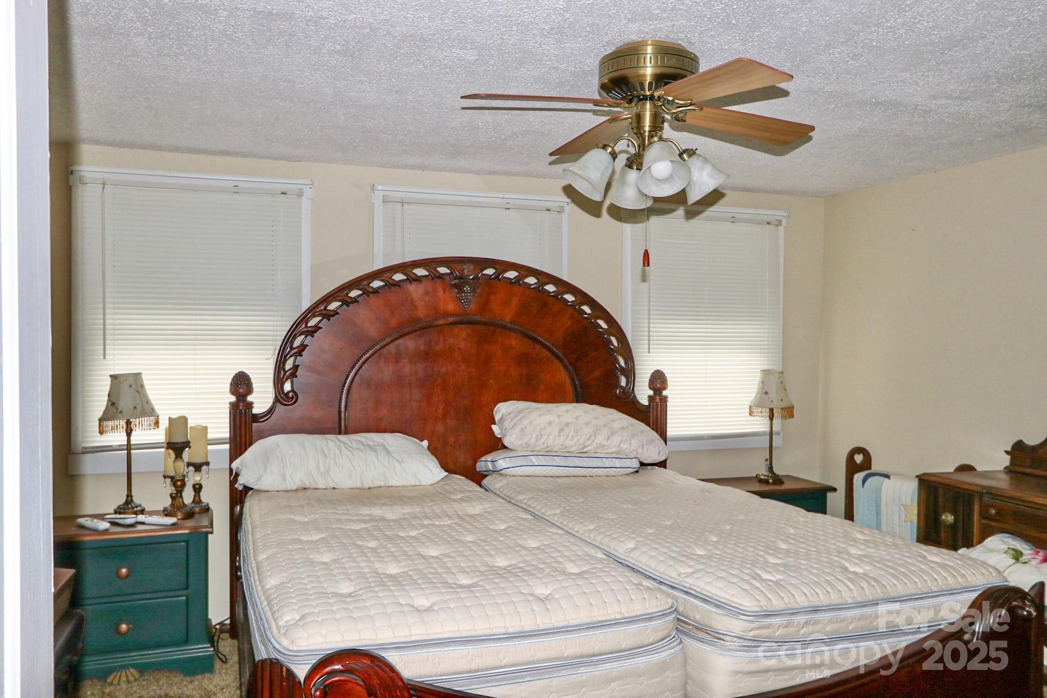 11979 Sparta Road McGrady, NC 28649 - Photo 30 of 48 a bedroom with a bed and a chandelier