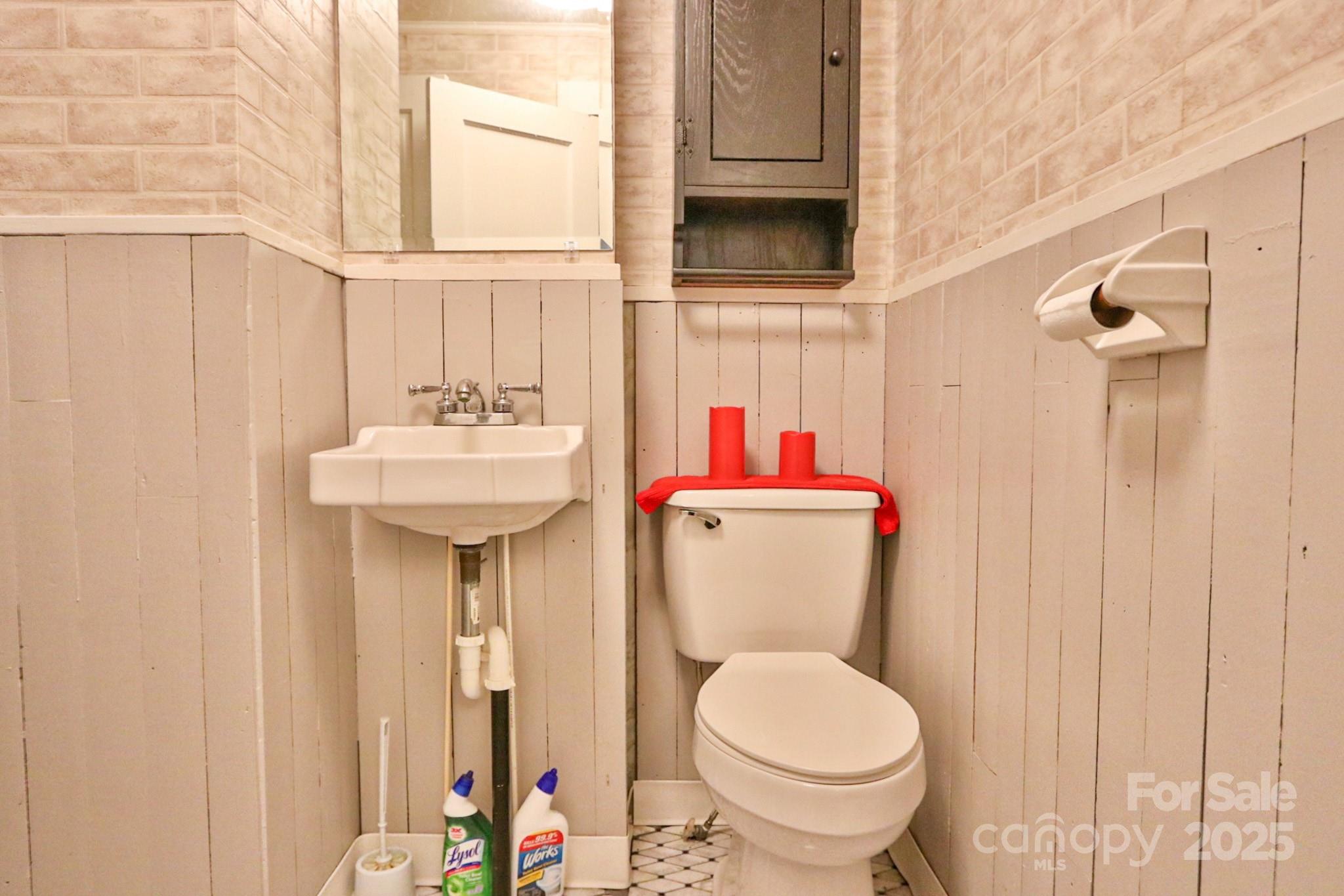 11979 Sparta Road McGrady, NC 28649 - Photo 32 of 48 a bathroom with a toilet sink and mirror