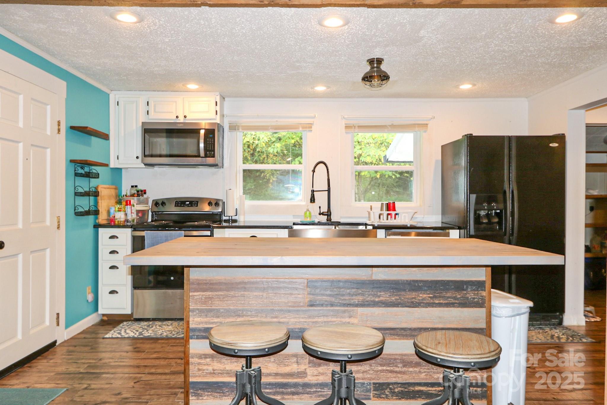 11979 Sparta Road McGrady, NC 28649 - Photo 10 of 48 a large kitchen with a stove a refrigerator and a sink