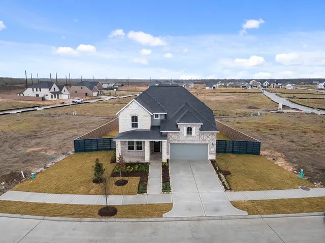 an aerial view of a residential houses with outdoor space