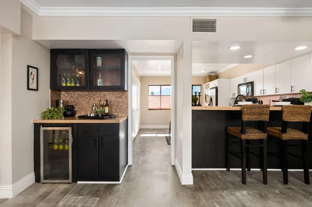 a kitchen with stainless steel appliances kitchen island granite countertop a refrigerator and cabinets