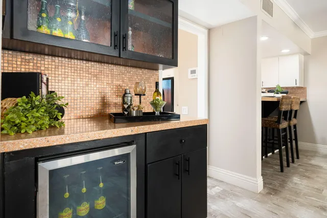 a kitchen with stainless steel appliances granite countertop a sink and a refrigerator