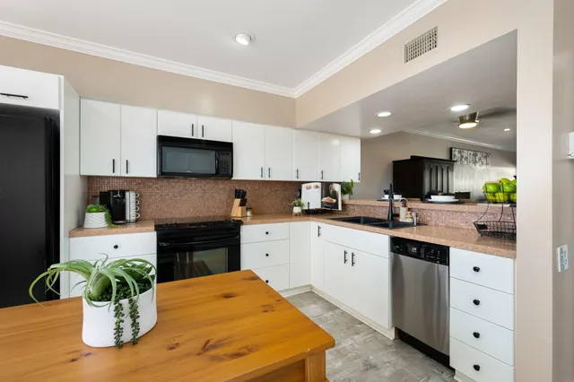 a kitchen with a table and chairs in it