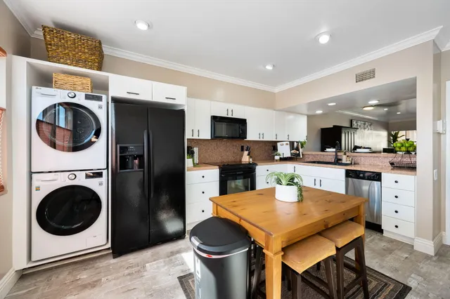 a kitchen with a stove a refrigerator and a sink