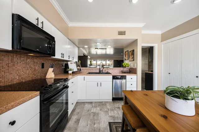 a kitchen with a sink stove and microwave