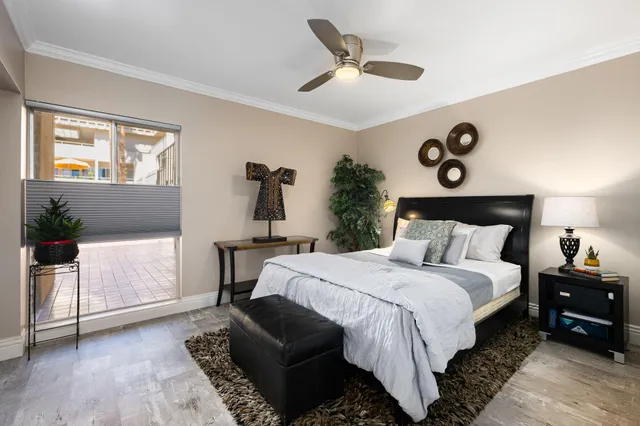 a bedroom with a bed and a chandelier