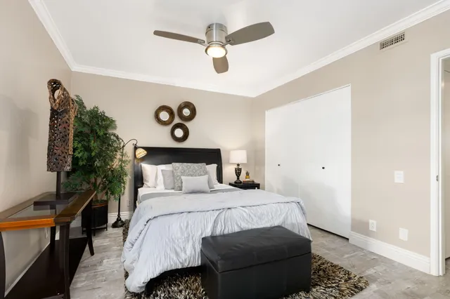 a bedroom with a bed and a chandelier