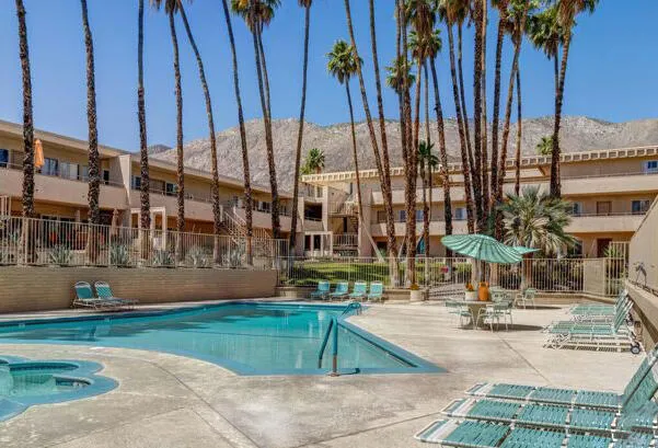 a swimming pool with outdoor seating and yard