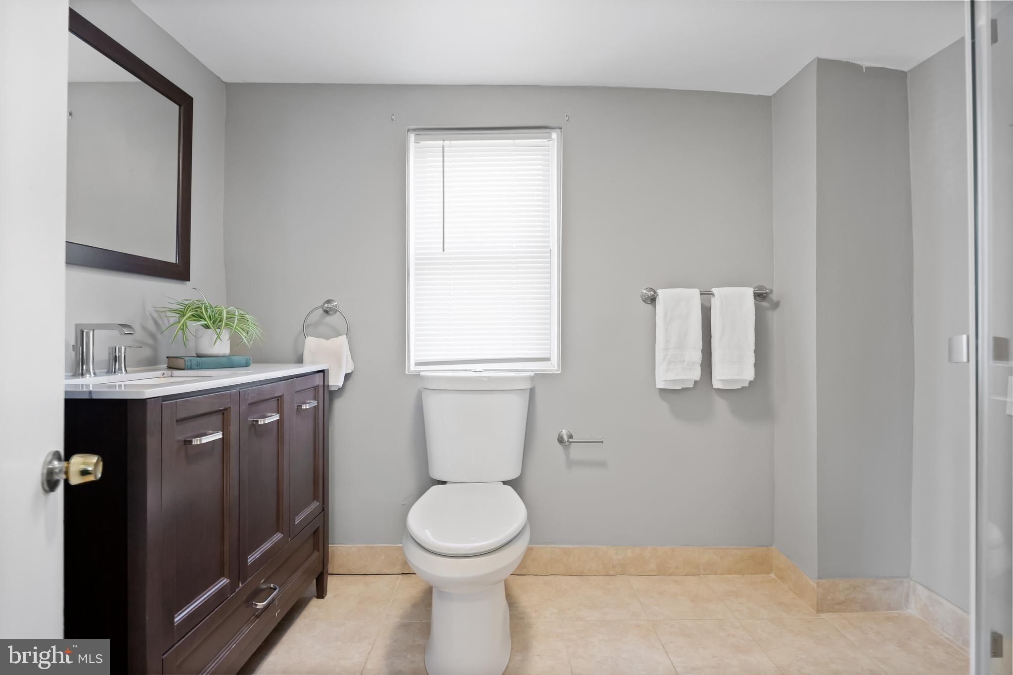 227 Whittier Avenue Moorestown, NJ 08057 - Photo 14 of 19 a bathroom with a toilet sink vanity and mirror