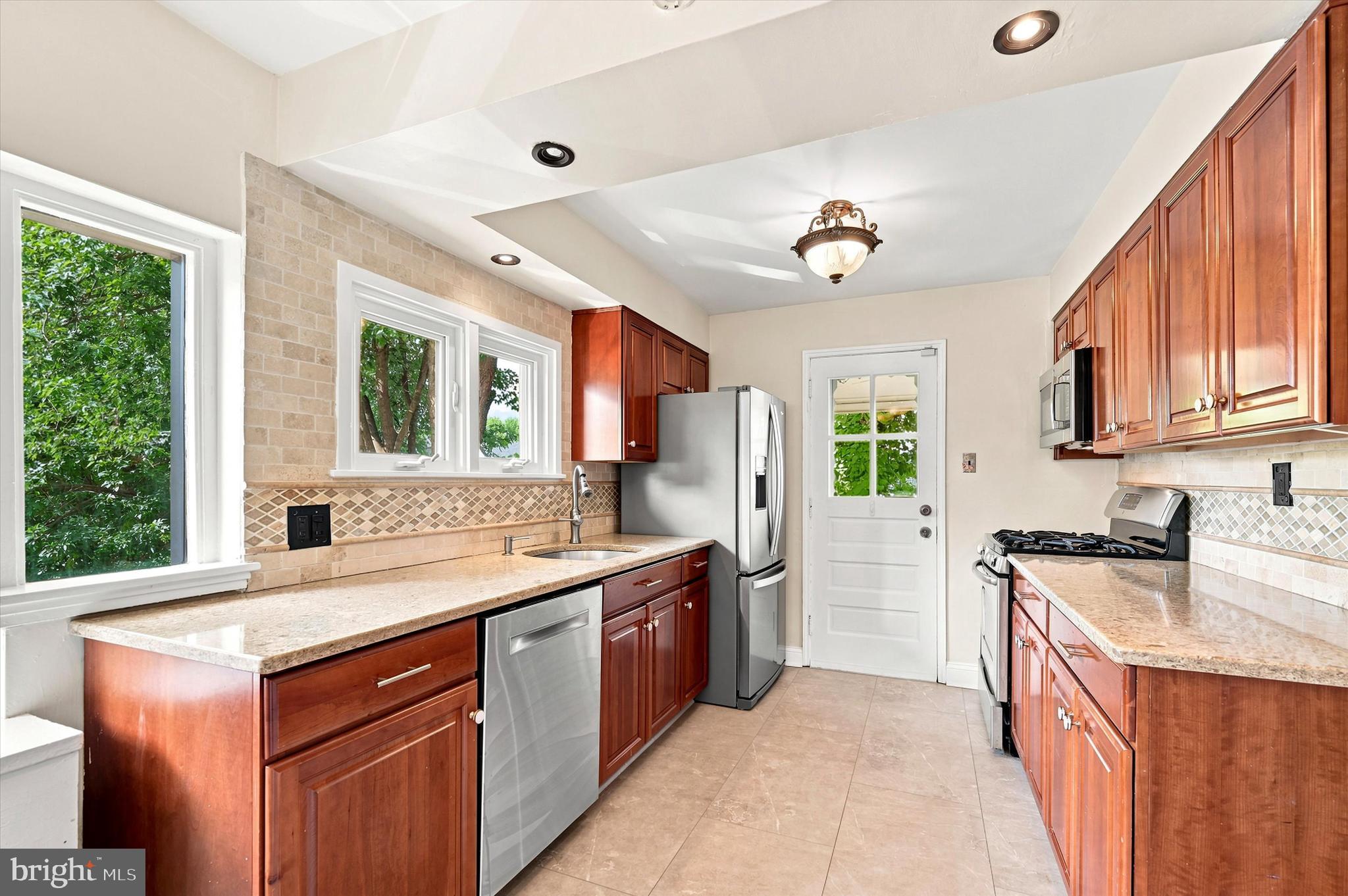 1468 Hampstead Road Wynnewood, PA 19096 - Photo 11 of 29 a kitchen with a stove sink and cabinets