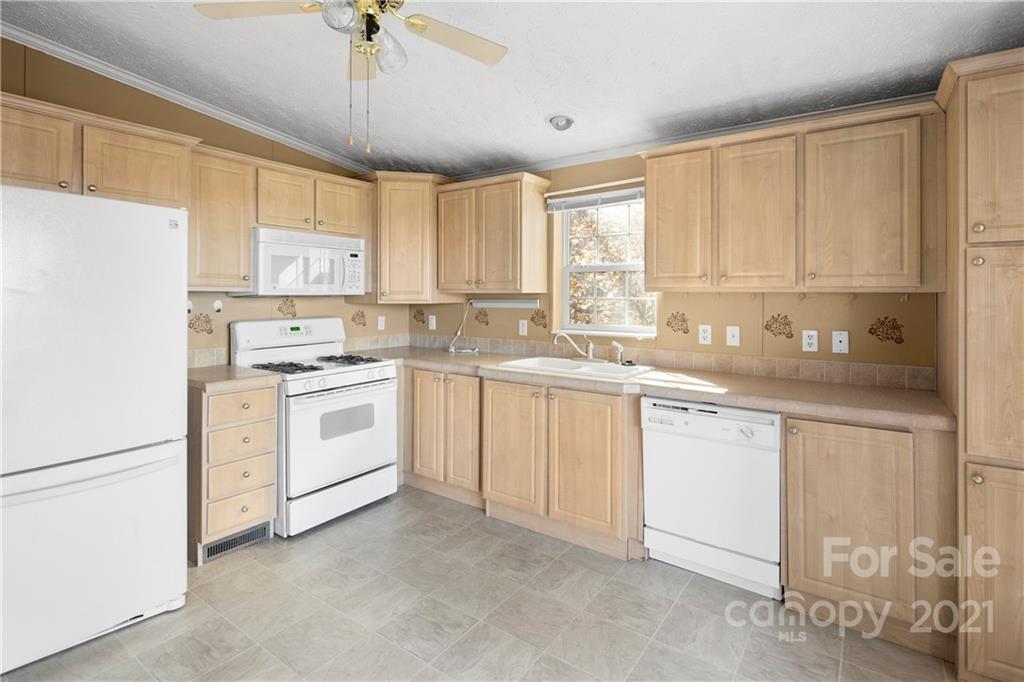 2226 Poplar Cove Road Clyde, NC 28721 - Photo 11 of 21 a kitchen with white cabinets white appliances and sink