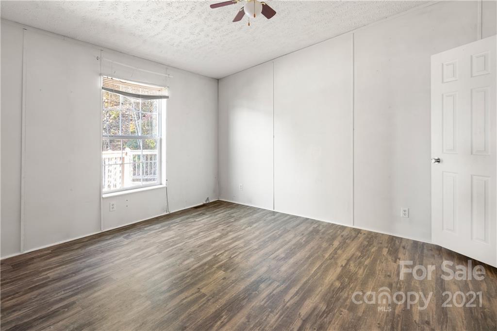 2226 Poplar Cove Road Clyde, NC 28721 - Photo 14 of 21 wooden floor in an empty room with a window