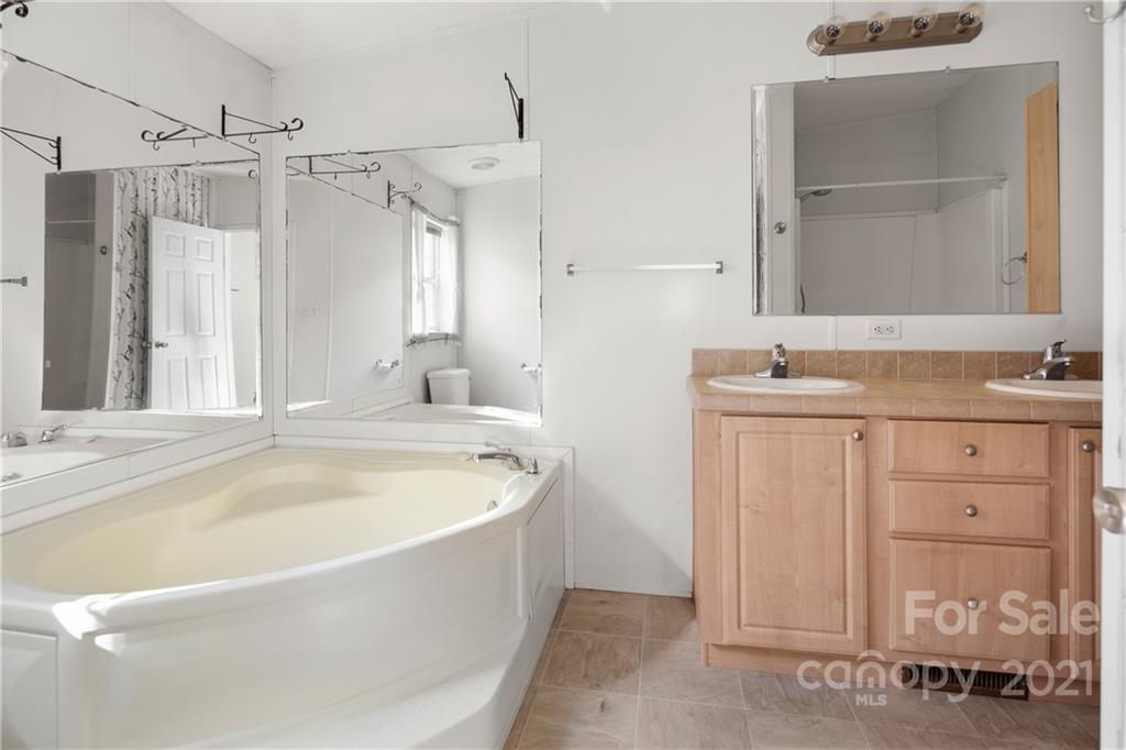 2226 Poplar Cove Road Clyde, NC 28721 - Photo 16 of 21 a bathroom with a bathtub and a sink