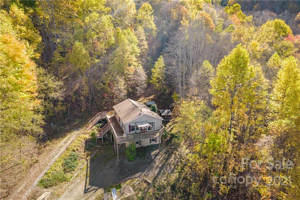 2226 Poplar Cove Road Clyde, NC 28721 - Photo 4 of 21 a view of a lake with a mountain in the back yard